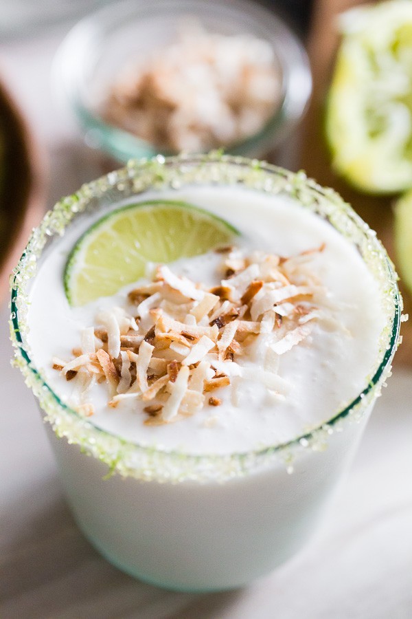 coconut lime frozen margarita served with a lime sugar rim.