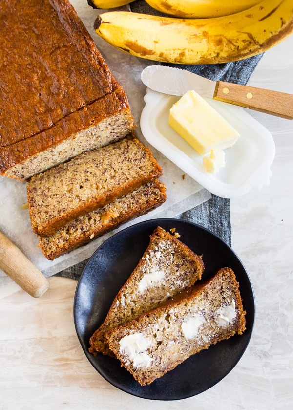 Coconut Rum Lime Glazed Banana Bread spread with butter. 