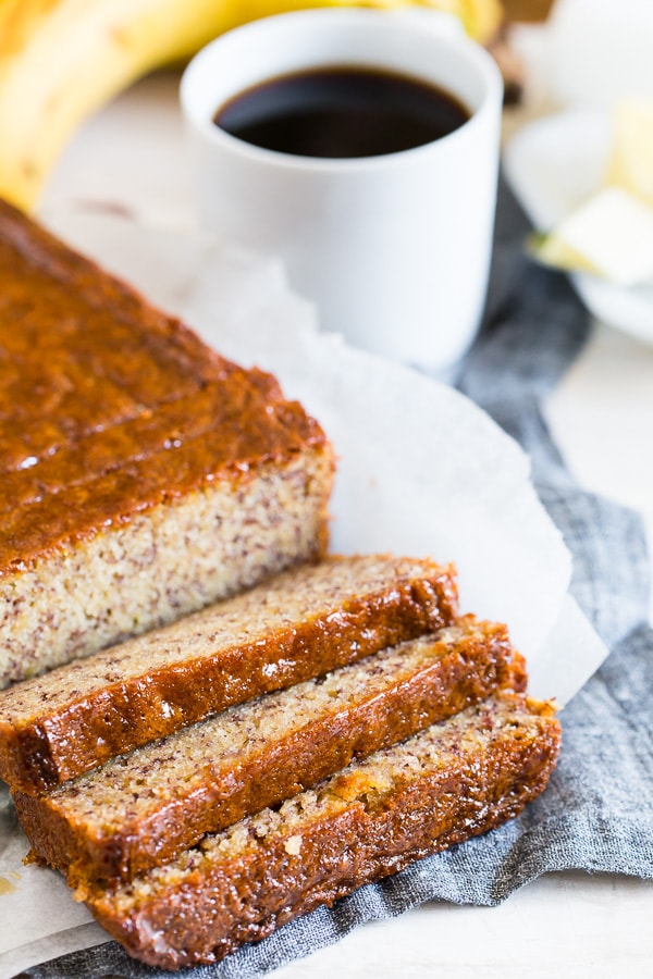 Coconut Rum Lime Glazed Banana Bread sliced on a table. 