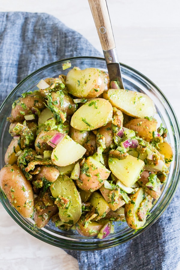 Herbed Dijon Mustard Potato Salad in a bowl with a spoon.