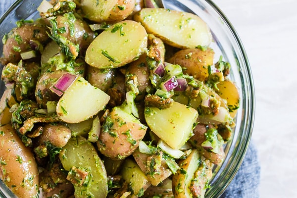 Herbed Dijon Mustard Potato Salad in a glass serving bowl.