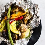 This chicken sausage and vegetable foil packet dinner is super simple to make and perfect for summer. Packed full of chicken sausage, sweet peppers, zucchini, yellow squash, red onion, green beans and drizzled with a herbed olive oil. You'll love this simple dinnertime recipe!