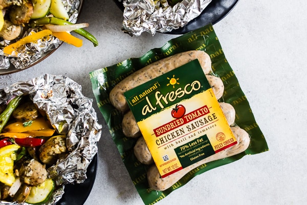 This chicken sausage and vegetable foil packet dinner is super simple to make and perfect for summer. Packed full of chicken sausage, sweet peppers, zucchini, yellow squash, red onion, green beans and drizzled with a herbed olive oil. You'll love this simple dinnertime recipe!