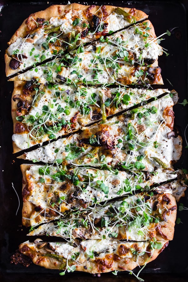 Asparagus Mushroom Burrata Pizza sliced on a sheet pan.