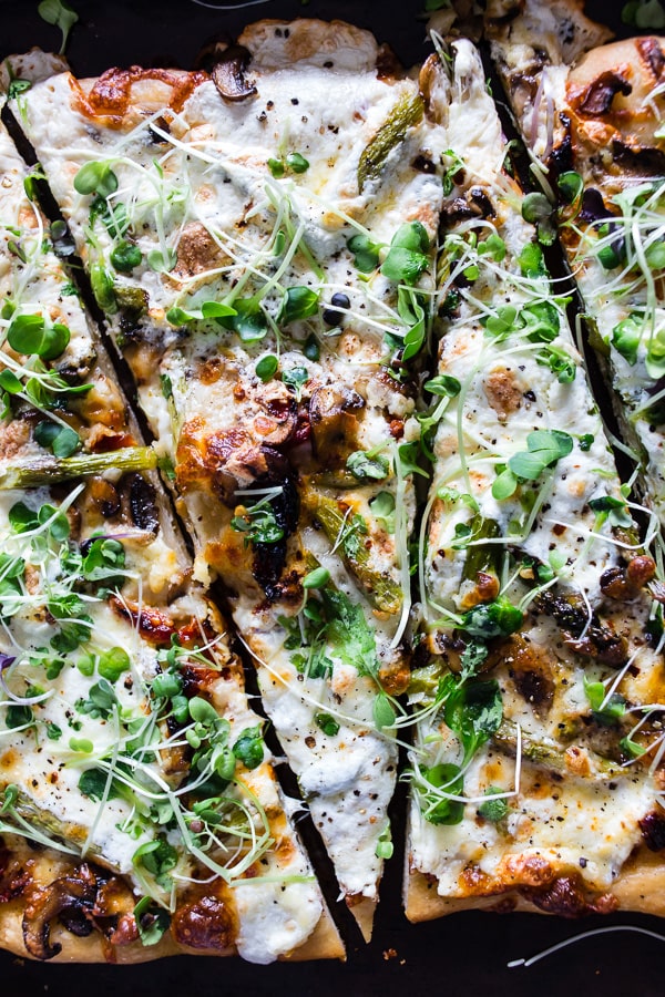 Asparagus Mushroom Burrata Pizza sliced on a sheet pan.