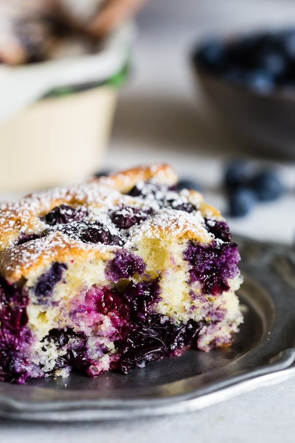 Blueberry Lemon Ricotta Olive Oil Cake sliced on a plate.