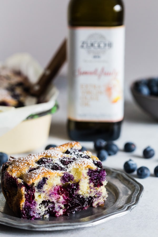 Blueberry Lemon Ricotta Olive Oil Cake sliced on a small dessert plate.
