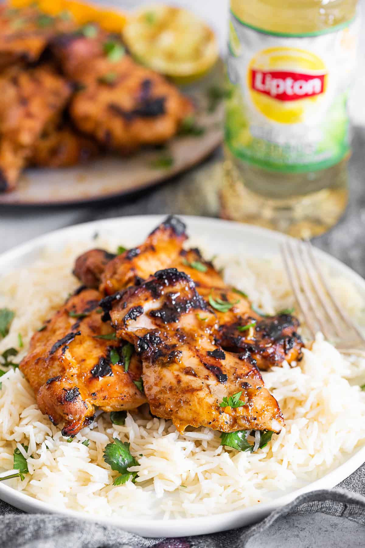 chili lime chicken thighs on top of a bed of rice. 
