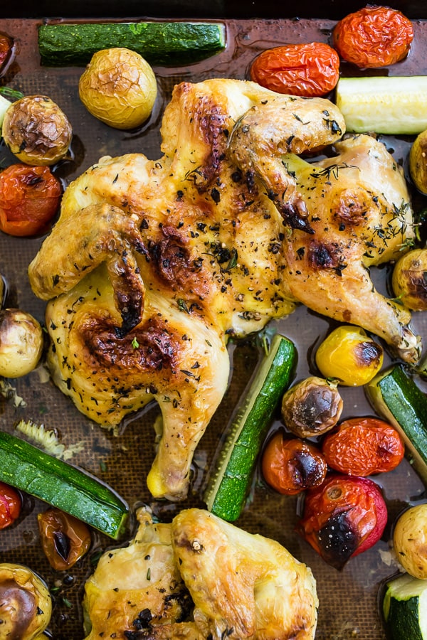 This sheet pan spatchcocked Cornish hens with summer vegetables is the perfect weeknight dinner. It all bakes up on one sheet pan and is packed with perfectly crisp Cornish hens, zucchini, baby potatoes and cherry tomatoes all tossed in an olive oil, oregano, thyme mixture. You'll love this sheet pan meal!