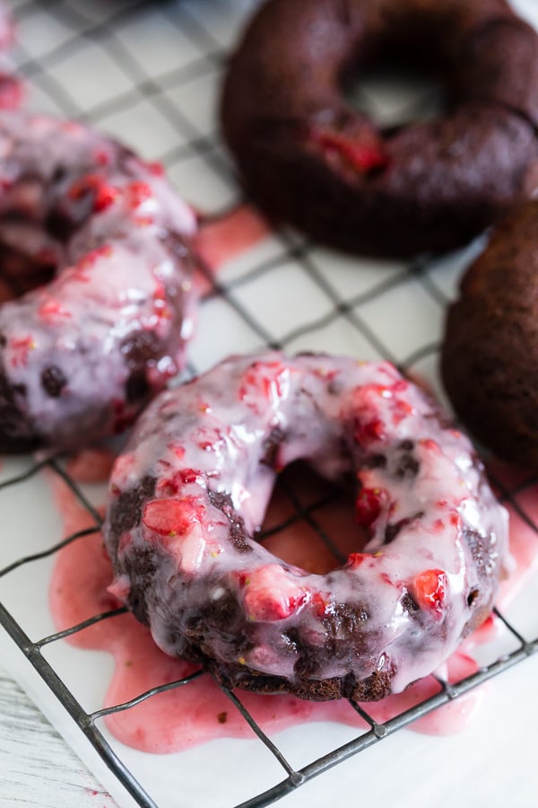 These baked chocolate donuts are studded with fresh strawberries, chocolate chips and topped with a homemade strawberry glaze. Trust me, if you love donuts you're going to go crazy over these chocolate strawberry baked donuts!