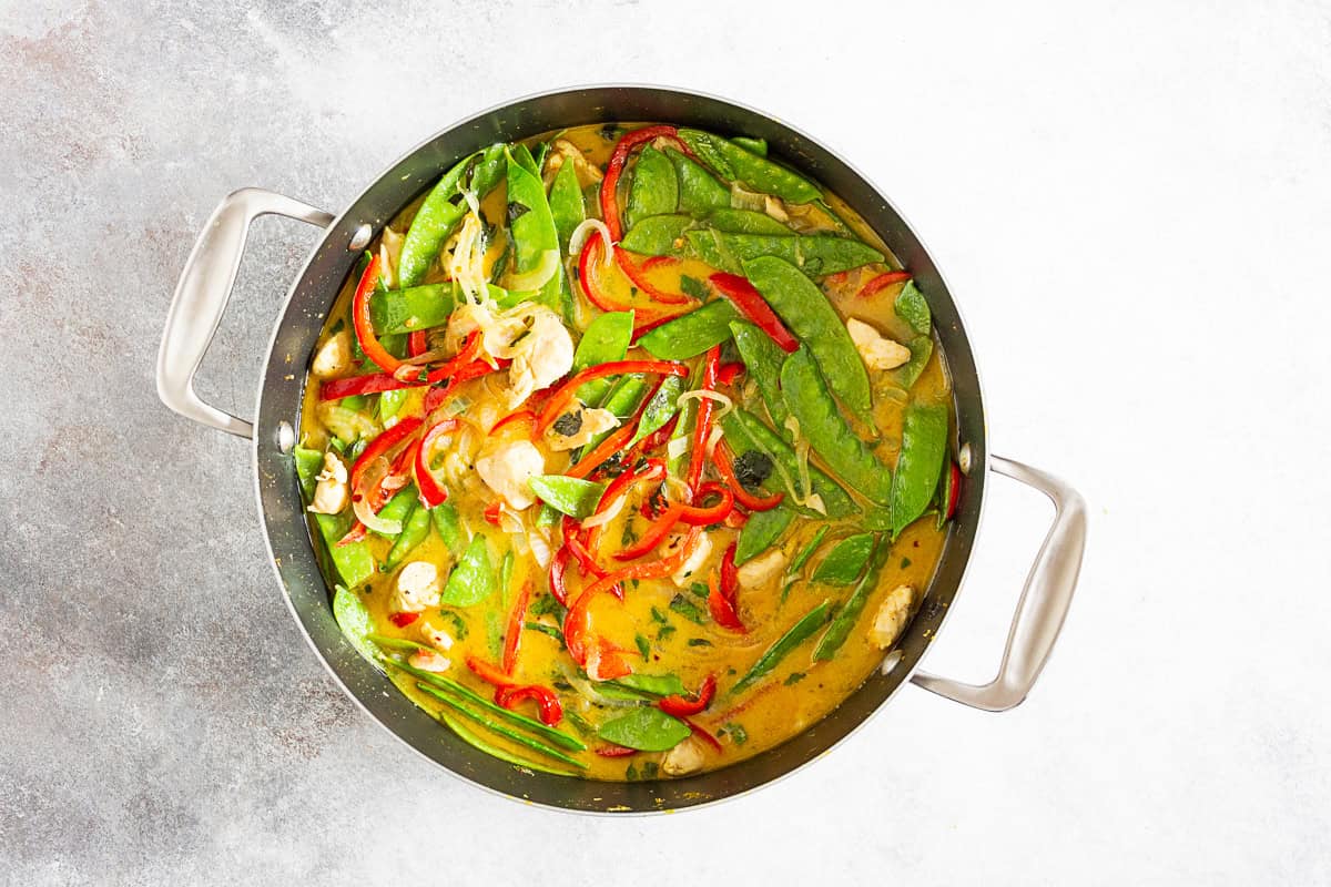 Green Chicken Curry in a round cooking skillet. 