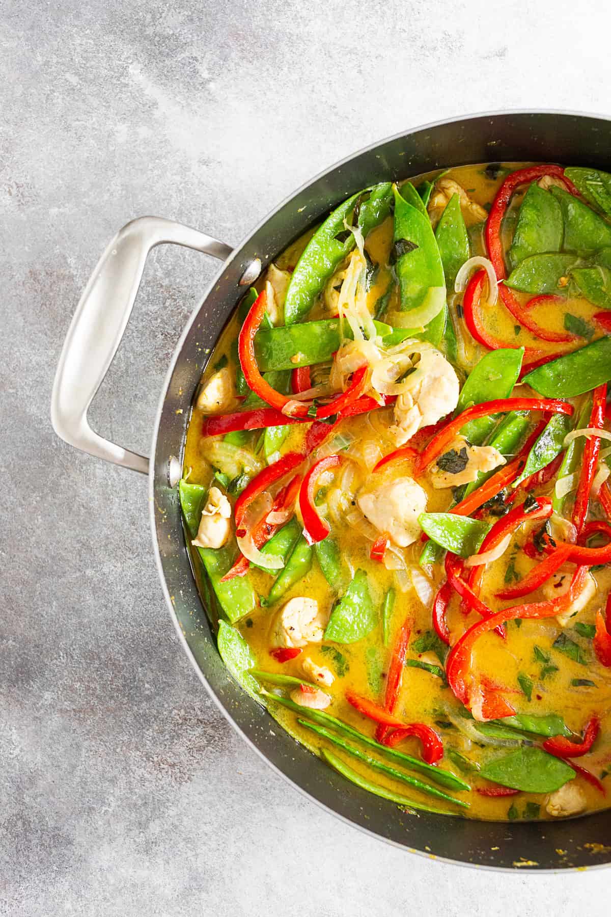 Green Chicken Curry in a large cooking skillet. 