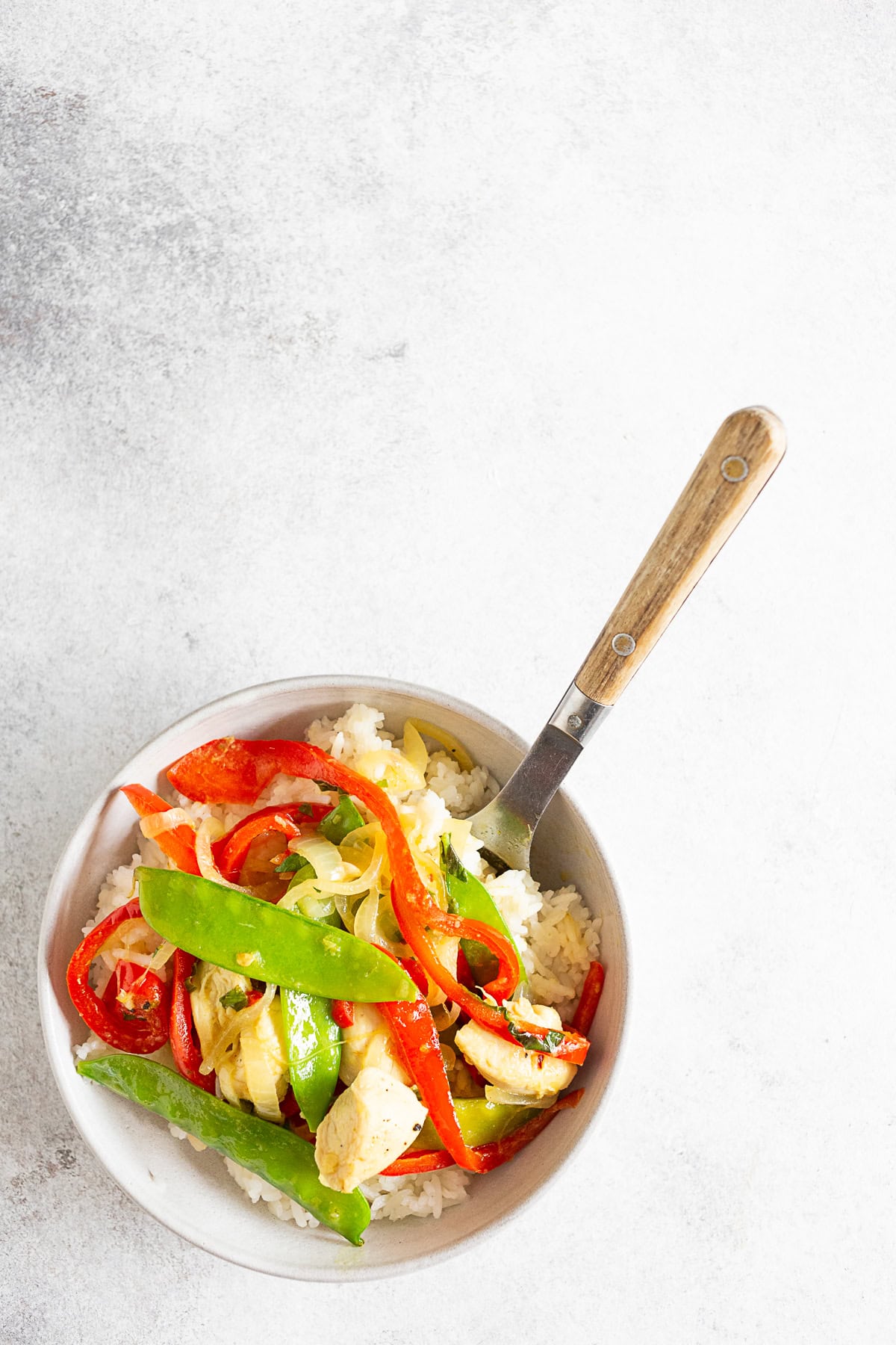 Green Chicken Curry in a bowl with a spoon. 