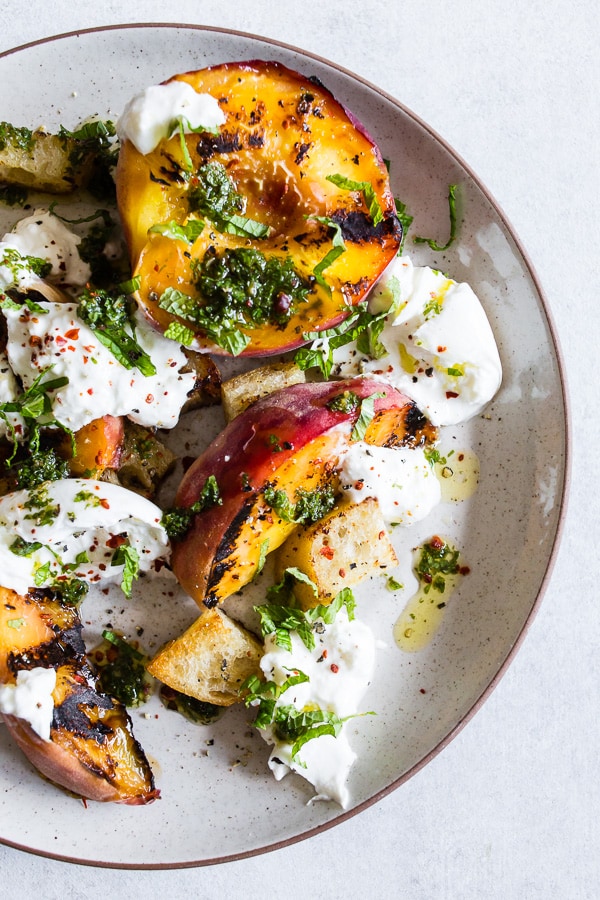 grilled peach burrata salad on a plate.