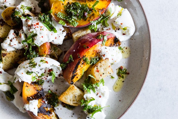 grilled peach burrata salad on a plate.