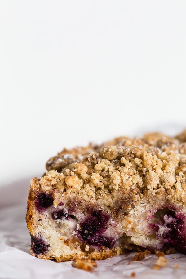 A cut mixed berry coffee cake to show the studded berries. 