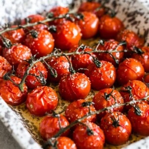These on the vine roasted tomatoes are the packed full of flavor and the perfect use for all your summer tomatoes. Perfectly roasted and great on salads, thrown in pasta or just eaten plain. So simple and easy to make!