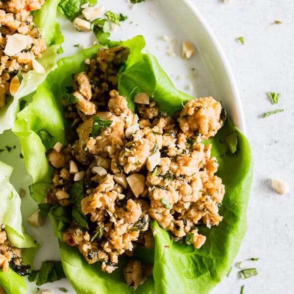 These Thai ground chicken lettuce cups are a super simple dinner that is packed full of flavor and perfect for a light summer dinner. Ground chicken mixed with ginger, lemongrass, fish sauce, soy sauce and sprinkled with chopped peanuts and lots of cilantro. You'll love these lettuce cups!