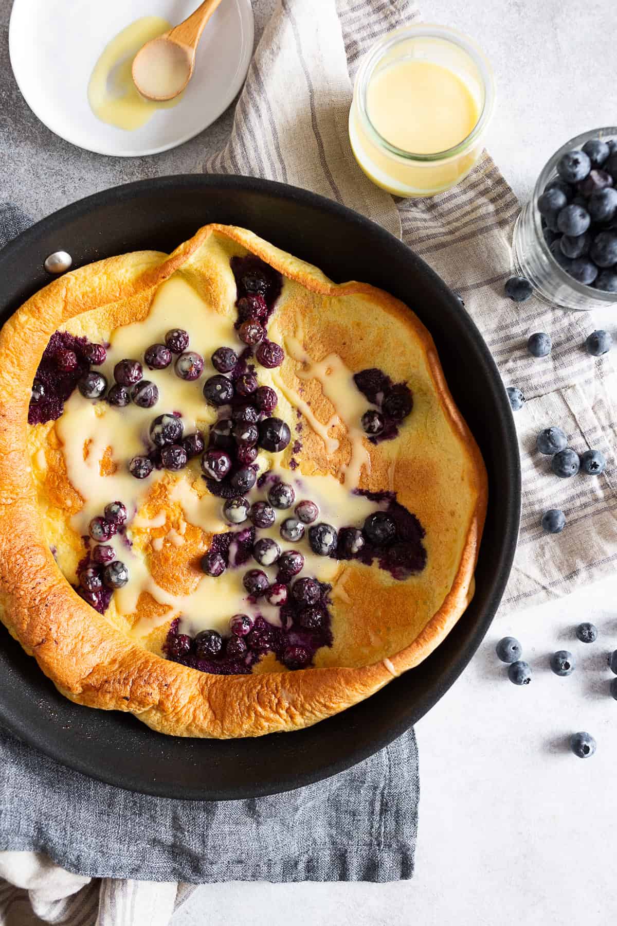 Blueberry Dutch Baby in a pan.