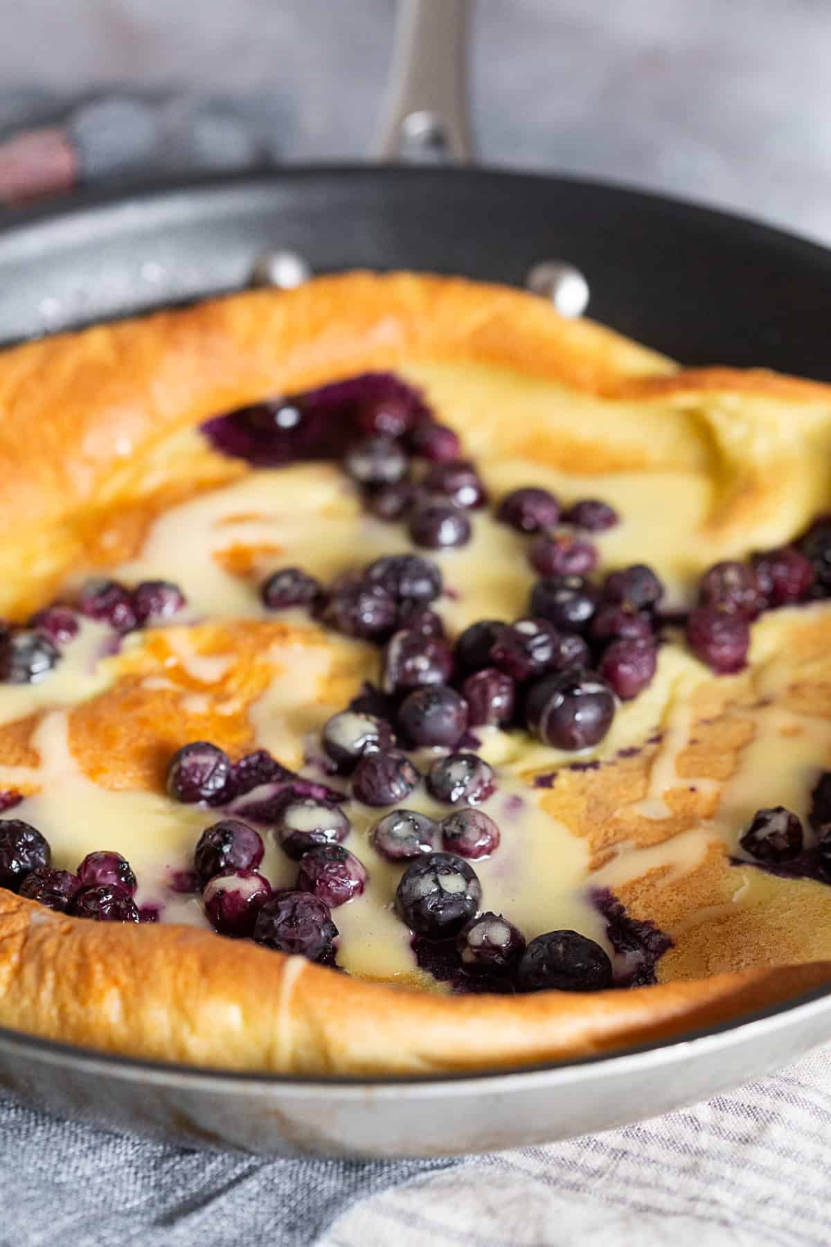 Blueberry Dutch Baby with extra blueberries on top.