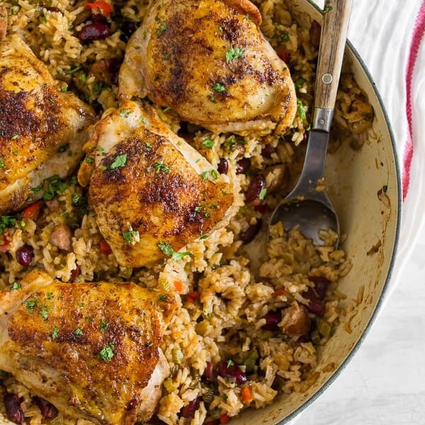 This one pot Cajun chicken and rice is the perfect fall meal. Packed full of flavor and prepared all in one pot. Crispy roast Cajun spiced chicken thighs on top of seasoned rice packed with Andouille sausage and red kidney beans. You’ll love how easy it is to throw together and clean up is a breeze.