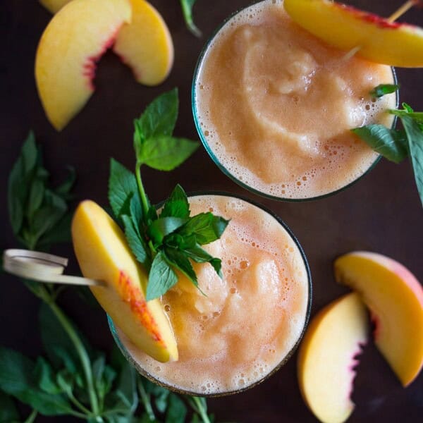 These peach tea bourbon slushies are the perfect summer addition. Full of peach tea, bourbon and lots of fresh peaches. This cocktail is summer perfection!