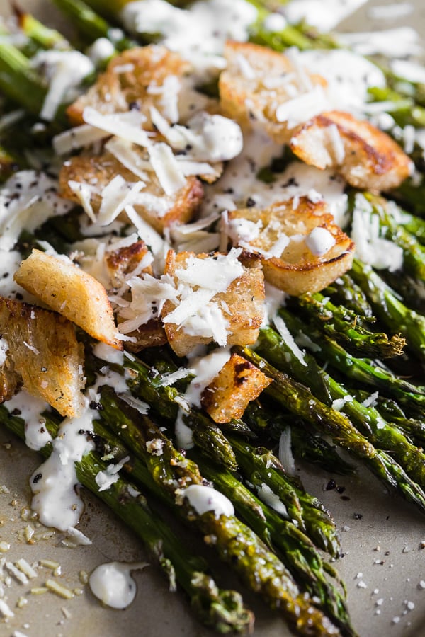 Roasted Asparagus Caesar Salad topped with croutons. 