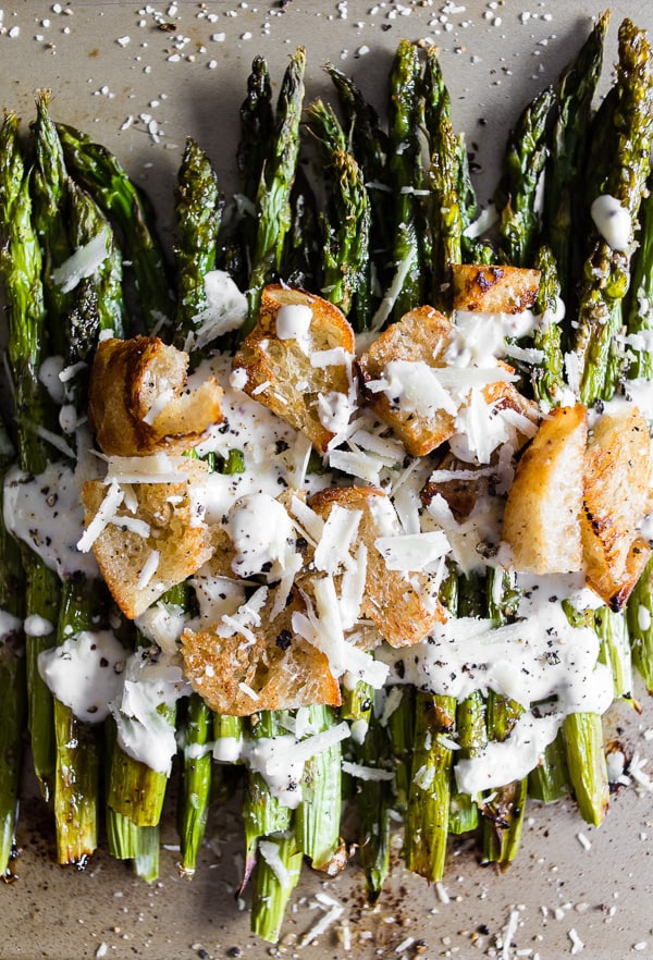Roasted Asparagus Caesar Salad topped with croutons, parmesan, and Caesar dressing. 