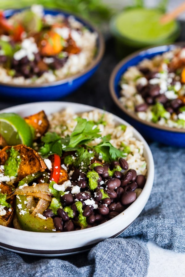 Sweet Potato Black Bean Burrito Bowls in a bowl topped with cilantro dressing.