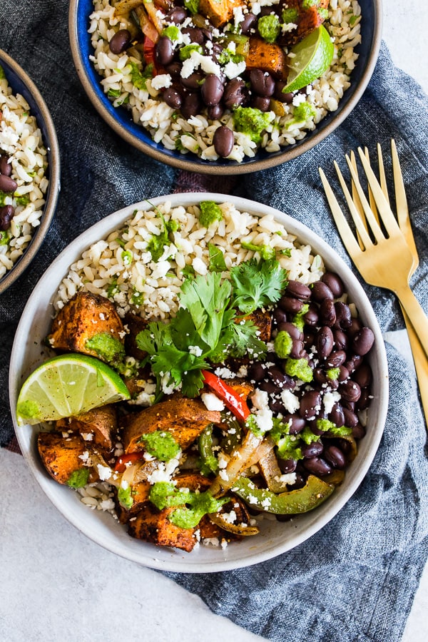 Sweet Potato Black Bean Burrito Bowls served with cilantro and lime.