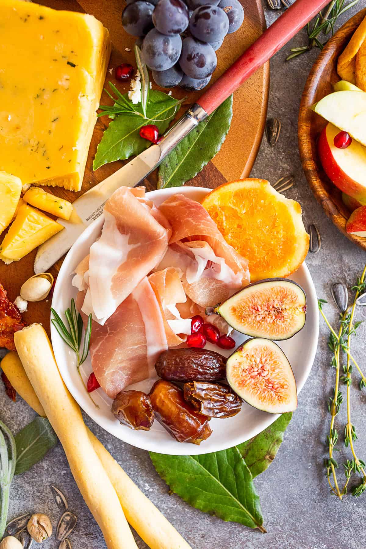 Prosciutto, figs, and dates on a small plate. 