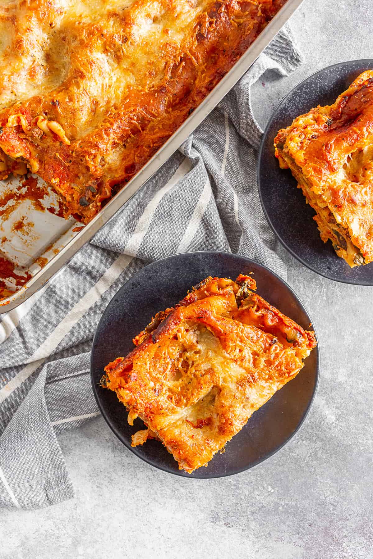 Italian Sausage Lasagna sliced onto two plates. 