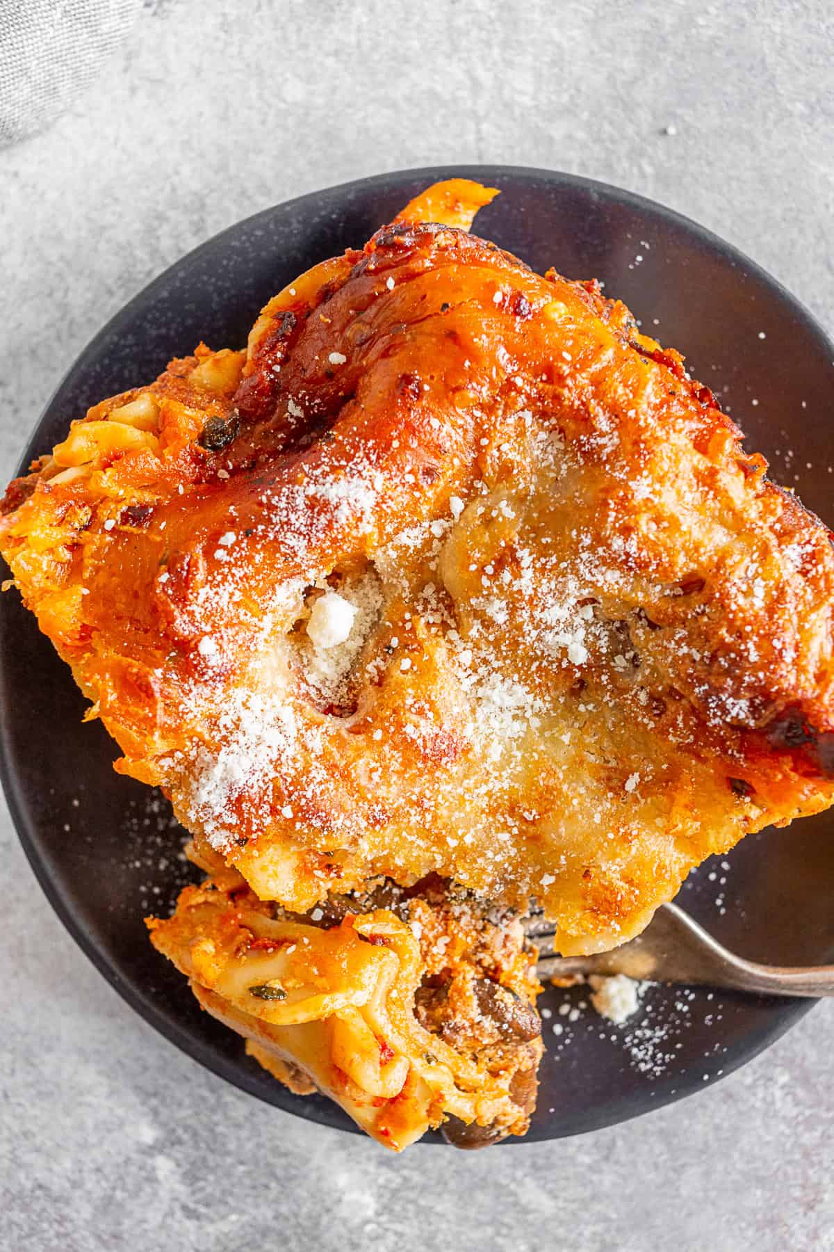 Italian Sausage Lasagna on a plate with a fork. 