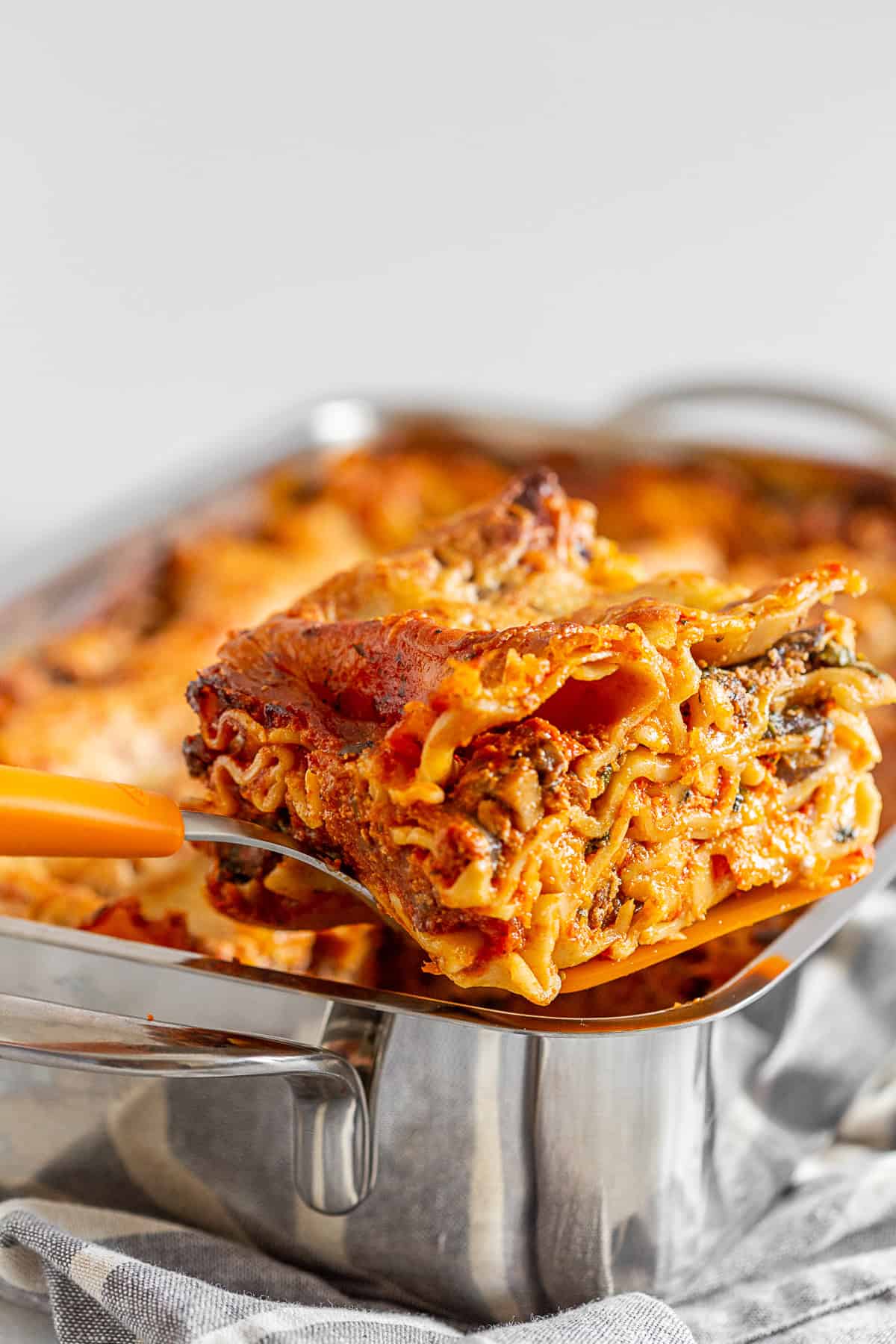 Italian Sausage Lasagna being cut out of the pan. 