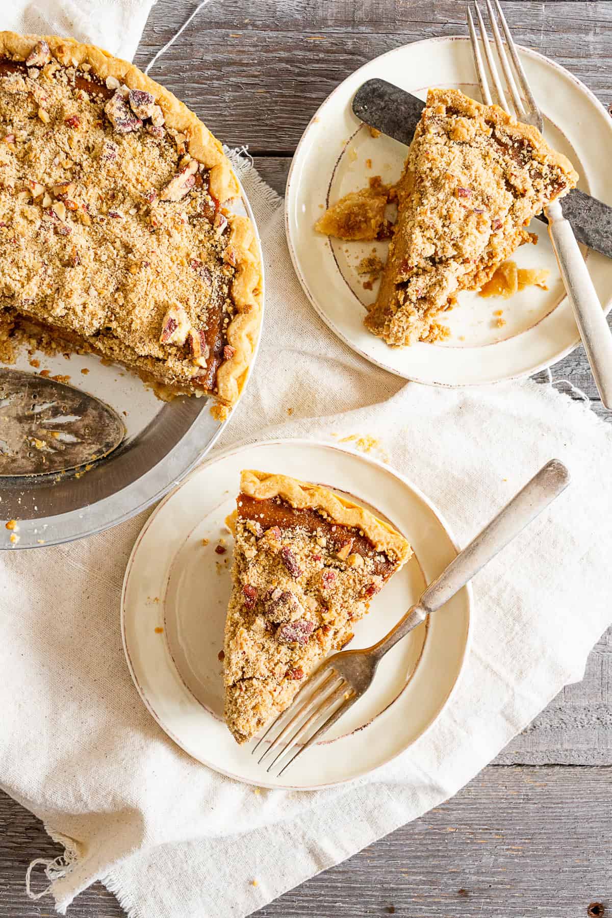 Streusel Topped Apple Butter Pumpkin Pie cut on plates.