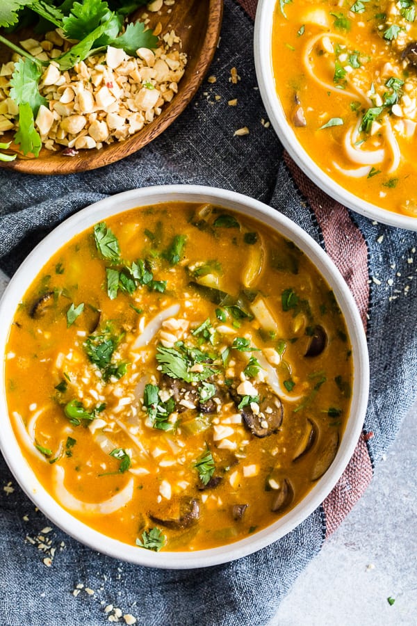 Vegan Red Curry Pumpkin Noodle Soup in two bowls. 
