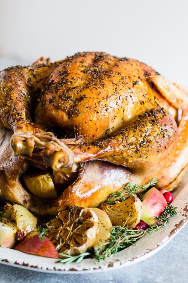 Garlic Herb Maple Roast Turkey on a white serving tray. 