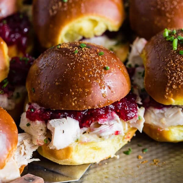 These baked cranberry cheddar turkey sandwiches are the perfect use for your leftover Thanksgiving turkey and cranberry sauce. What's not to love about delicious potato rolls topped with Thanksgiving leftovers?Β
