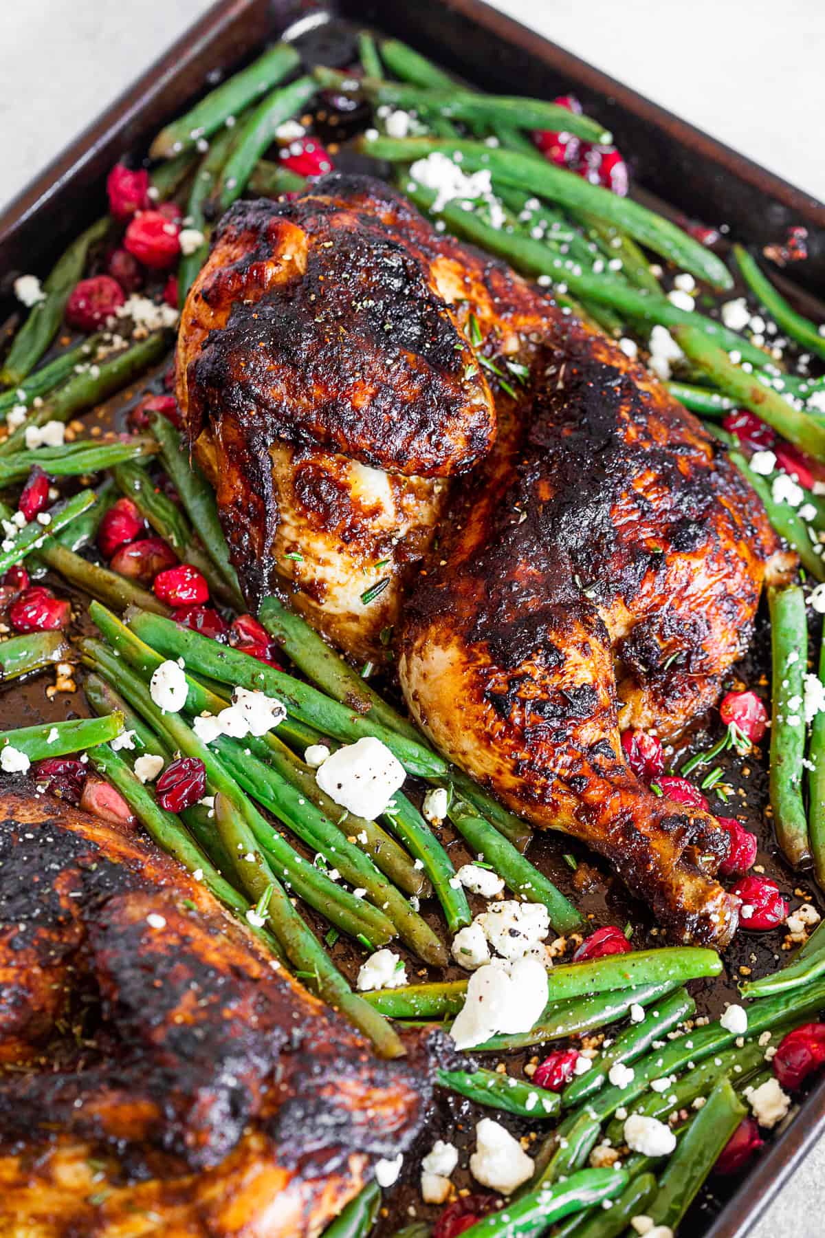 Sheet Pan Balsamic Chicken with Cranberry and Green Beans on a sheet pan.