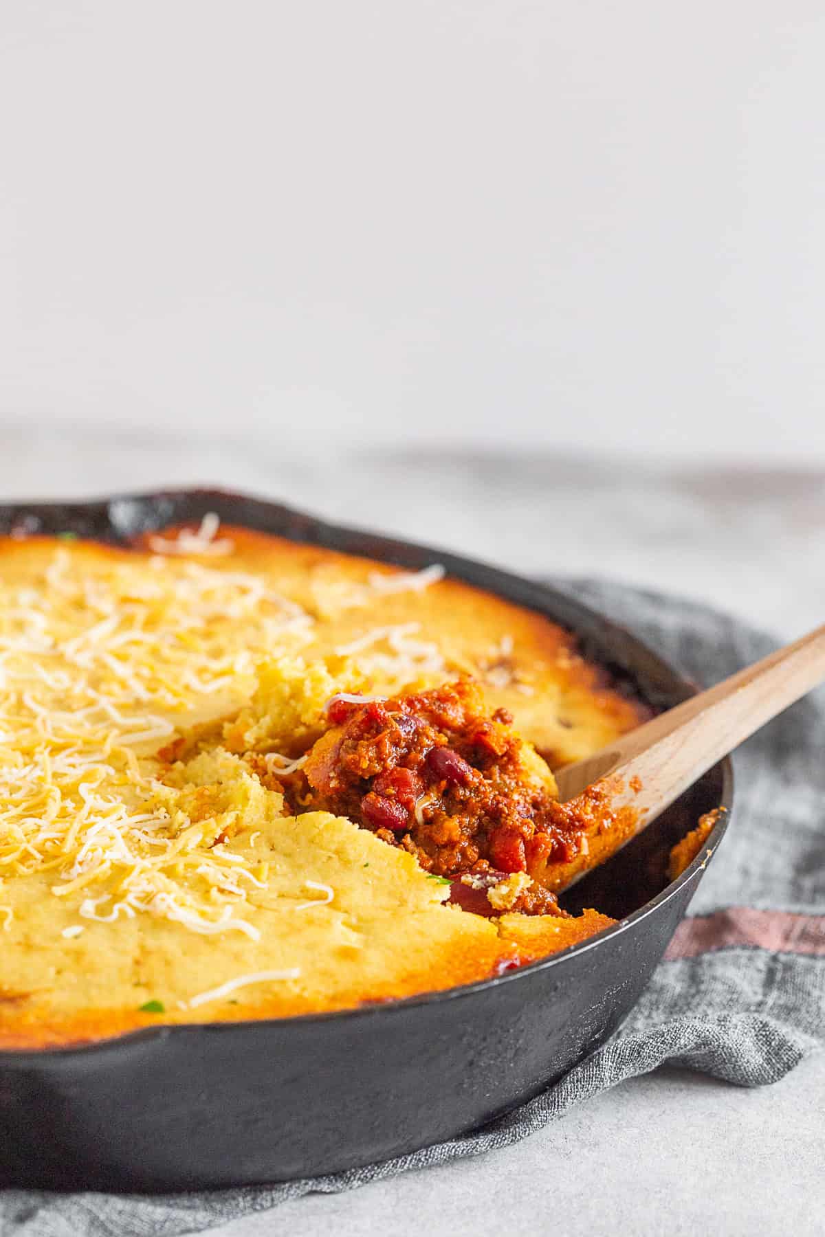 Buttermilk Cornbread Topped Chili in a cast iron skillet.