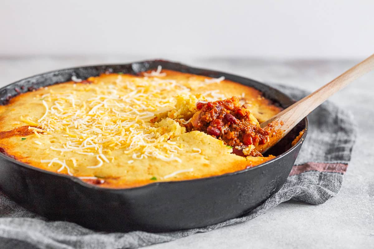 Buttermilk Cornbread Topped Chili in a skillet. 