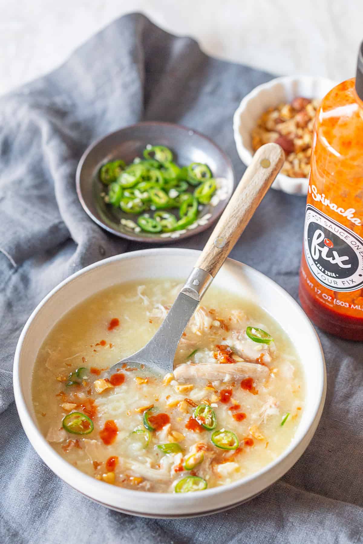 Instant Pot Asian Chicken and Rice Soup topped with sriracha. 