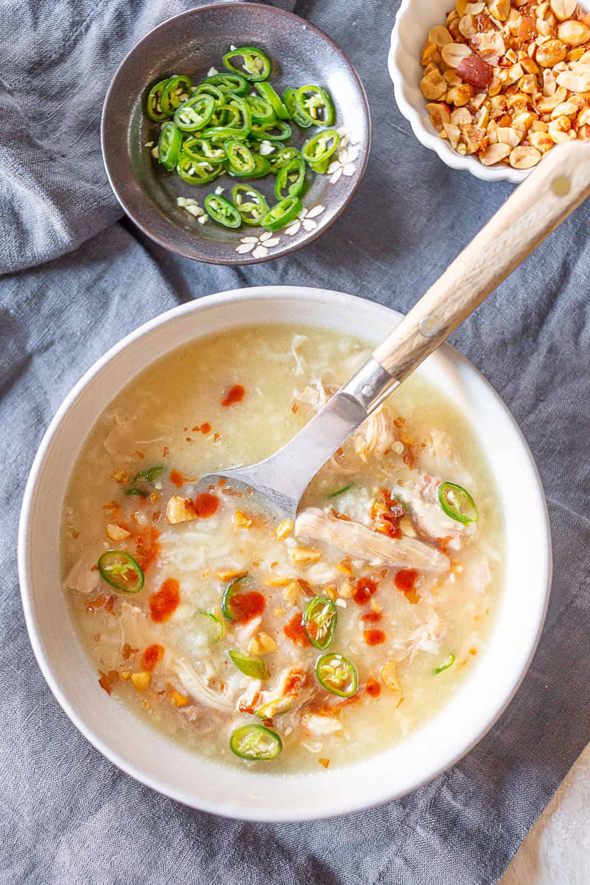 Instant Pot Asian Chicken and Rice Soup in a white bowl with a spoon. 