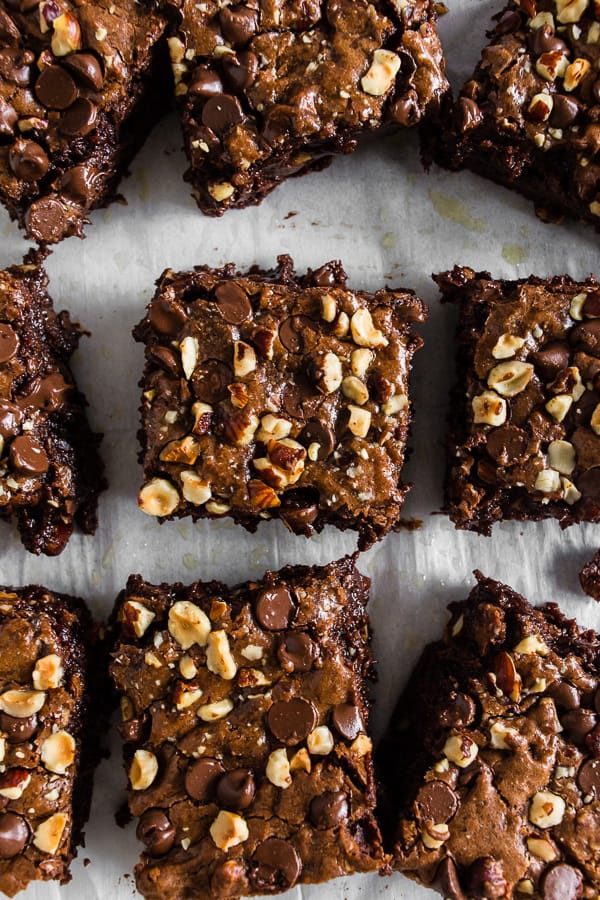 Hazelnut Buckwheat Brownies cut on parchment paper. 