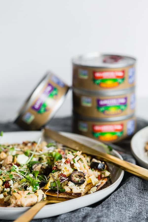 Mediterranean Tuna Salad Flatbread on a plate with a fork and knife. 