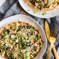 This Mediterranean tuna salad flatbread is the perfect protein and vegetable packed meal. Delicious albacore and yellowfin tuna mixed with lemon, parsley, sun dried tomatoes, capers, black olives, shallots, dill and artichoke hearts all piled high on a whole wheat pita and sprinkled with feta cheese and micro greens. You'll love this simple flavor packed lunch or dinner. 