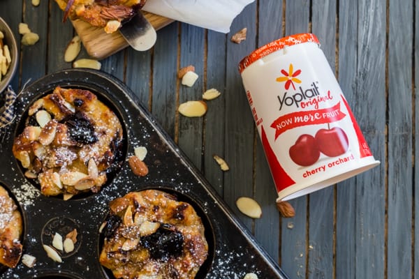 Cherry Yogurt French Toast Cups sitting next to a cherry yogurt.