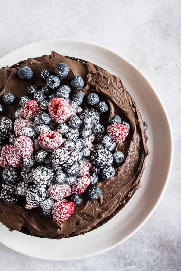 Espresso Dark Chocolate Mascarpone Frosting on a chocolate cake with berries.