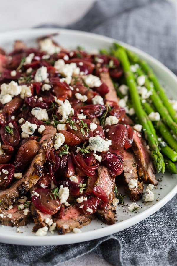 Grape and Blue Cheese Flank Steak on a white serving plate.