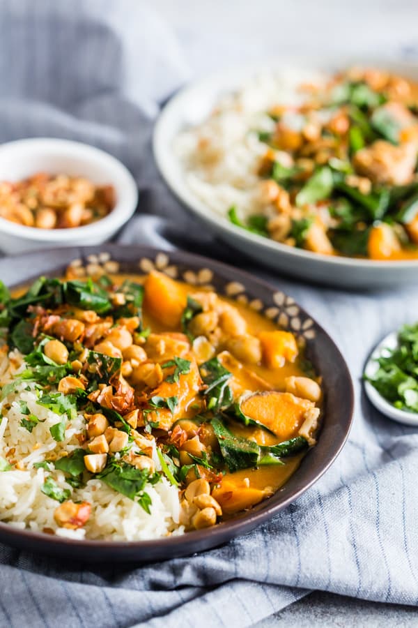 African Chicken Peanut Stew in a bowl topped minced peanuts and cilantro. 